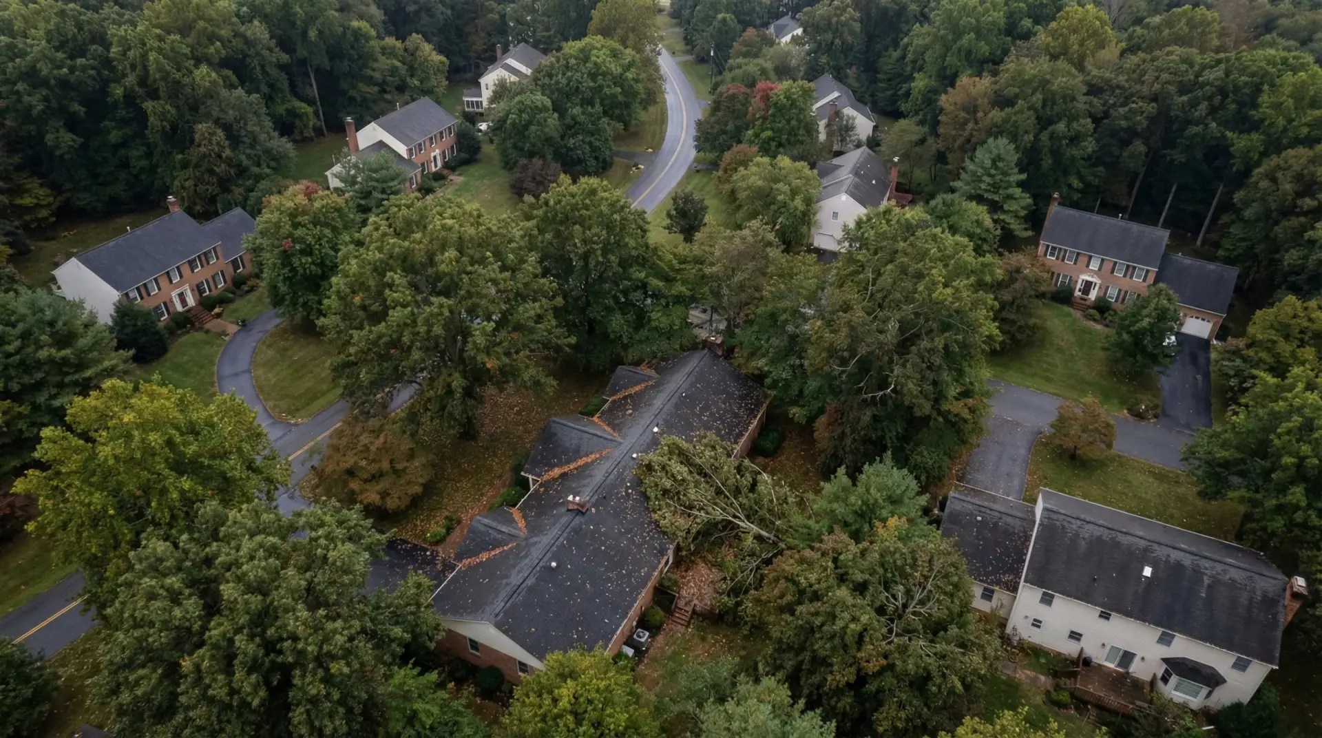 Aerial view of residential home with active roof replacement showing tear-off and new shingles installation in progress.